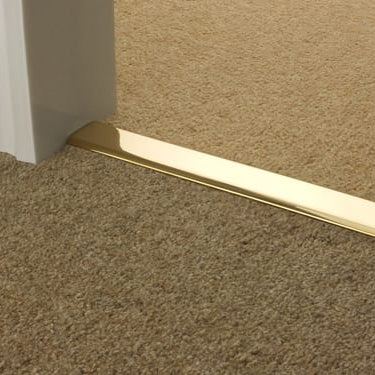 Premier DoubleZ 9 brass door threshold joining two beige carpets in doorway