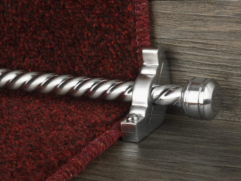 Sherbourne stair rod with spiral brushed rod in chrome fitted to burgundy stair carpet