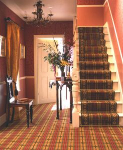 Country Sherwood stair rods in polished brass on cream staircase