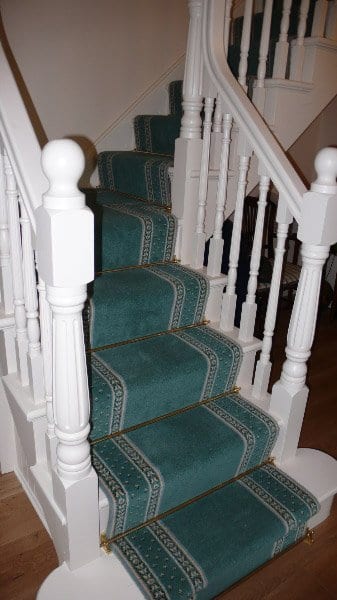 Windsor stair rods fitted on blue carpet runner