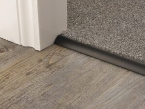 Curved edge threshold to join carpet to vinyl