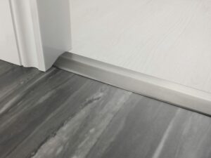 Premier 2 Way Ramp sloping door threshold, shown from laminate to vinyl, pewter
