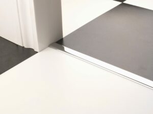 Premier Vinyl Edge floor edging, self-adhesive, shown between vinyl & timber, chrome