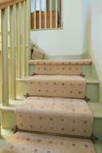 Chatsworth brass stair rods on runner carpet & green staircase