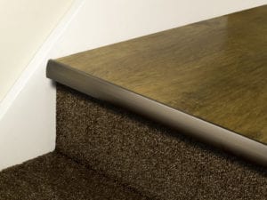 LVT Stair Nosing Full Bull strip fitted on front of step in antique bronze with rounded profile