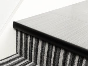 LVT Stair Nosing Full Bull strip along front of step in black with rounded profile