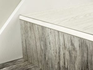 LVT Nosing No Bull fitted on vinyl covered step in satin nickel