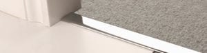 Door thresholds chrome joining beige carpet to tiles