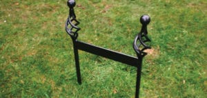 Black wrought iron free-standing wellington boot remover