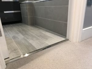 Laminate door threshold strip, chrome, joining carpet to bathroom LVY floor