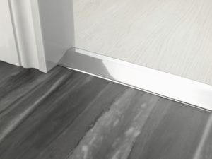 Door bar ramp that transitions from one floor level to another in chrome