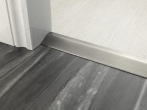 Door bar ramp that transitions from one floor level to another in pewter