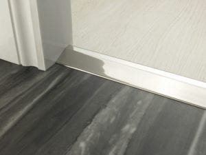 Door ramp in polished nickel that transitions from one floor level to another