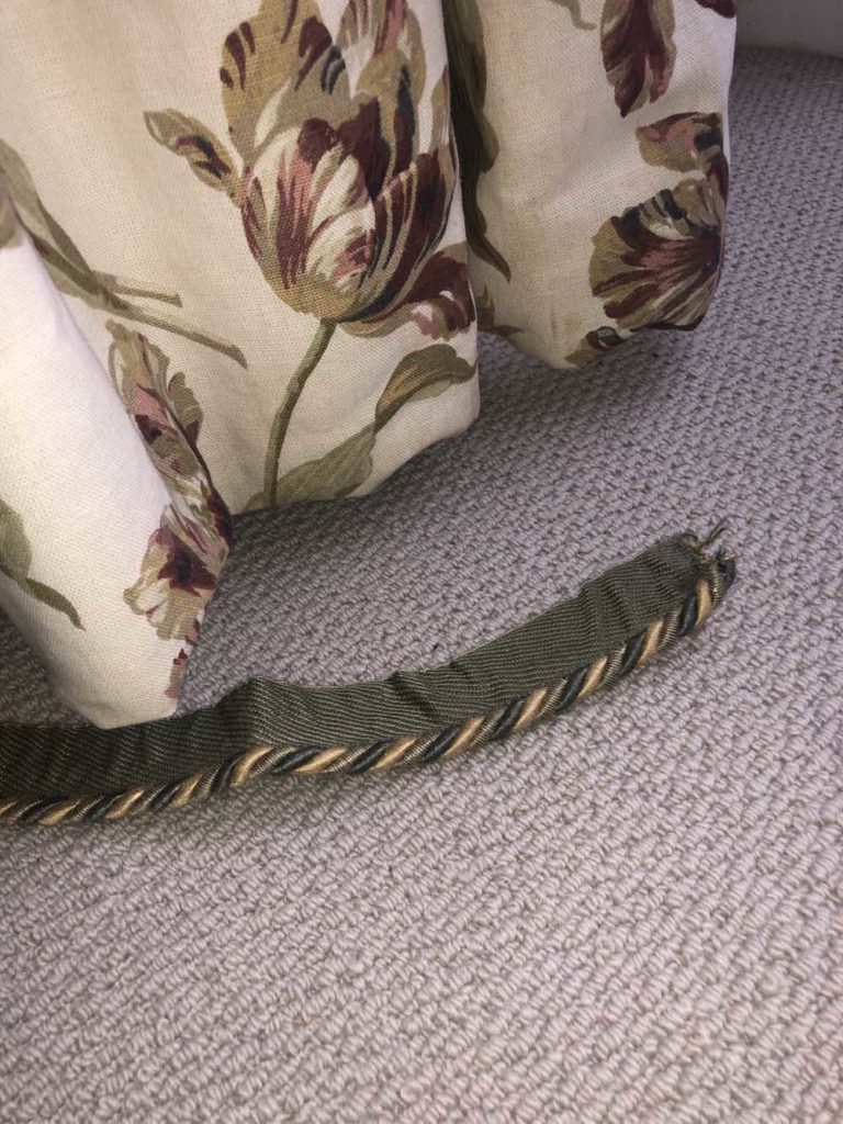 carpet tape in green on carpet next to curtains