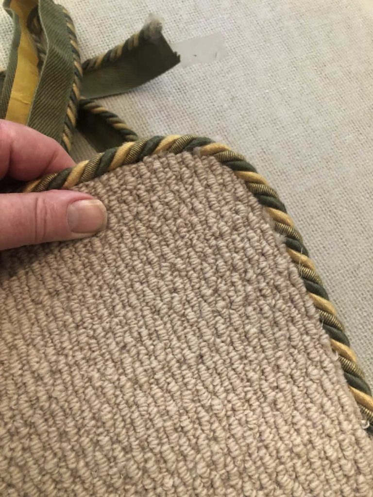 Easybind shown in Green Peter colourway binding edge of beige rug