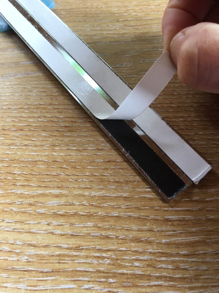 Self-adhesive strip on threshold on internal doors