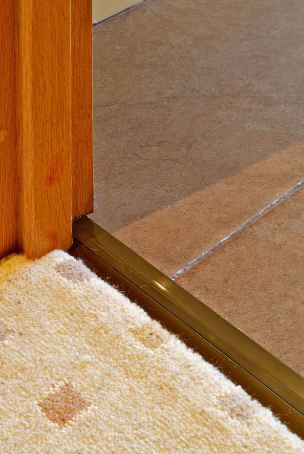 Posh door thresholds joining carpet to tile