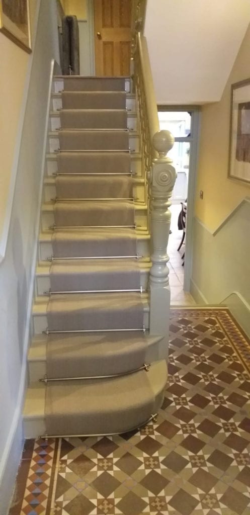 Curved stair rods fitted on stair runner