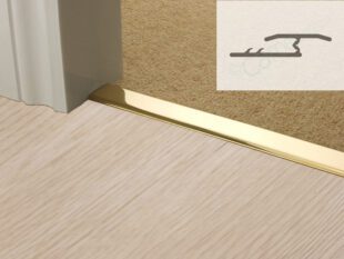 Polished brass metal threshold strip in doorway joining loop pile carpet to laminate plus profile diagram
