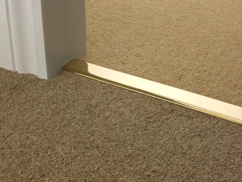 Premier DoubleZ 9 brass door threshold joining two beige carpets in doorway